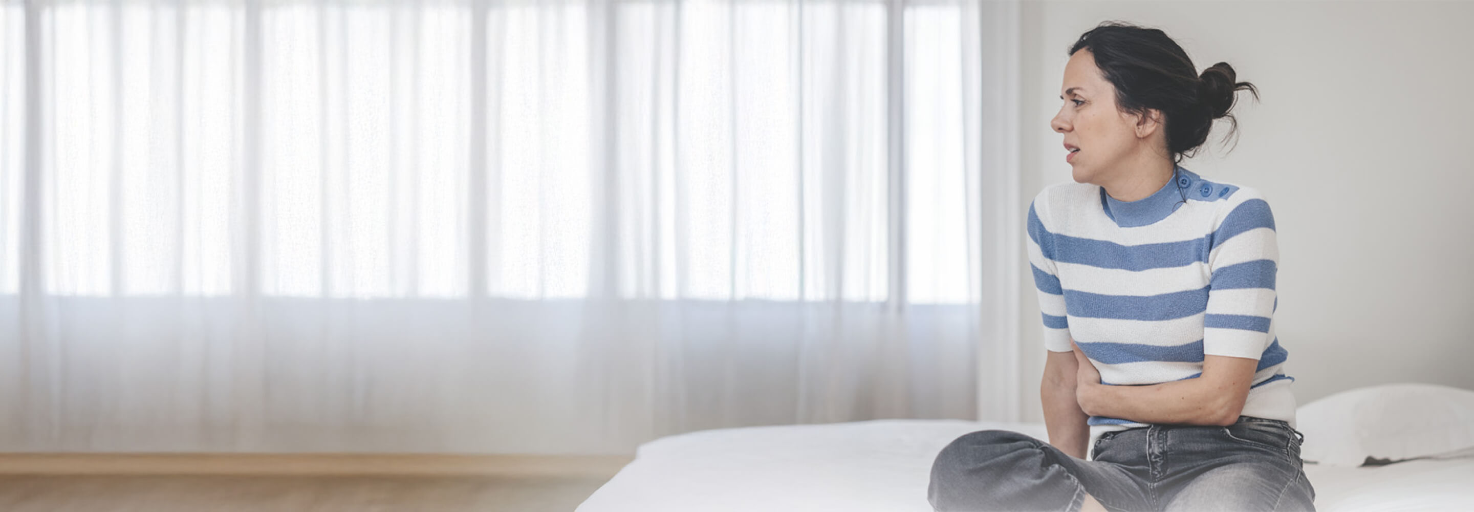 A woman in pain because of uterine fibroids