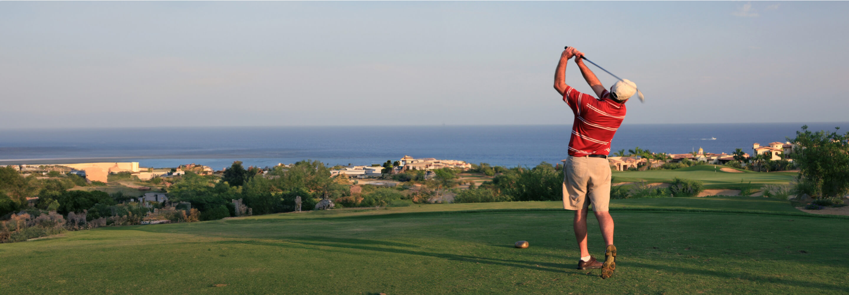 A man playing golf after a prostate artery embolization procedure